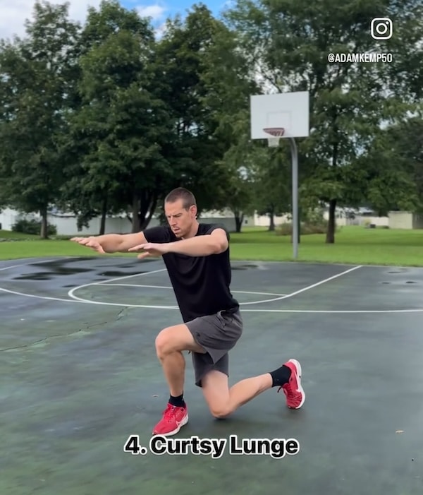 adam kemp doing the curtsy lunge exercise